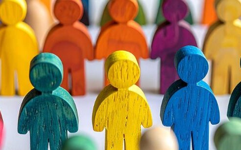 Colourful wooden figures in a line